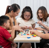 young adult and kids playing